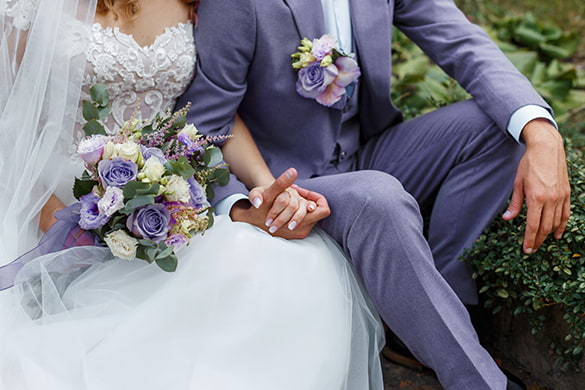 A bride and groom hold hands