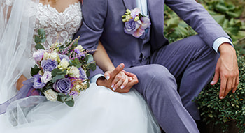 A bride and groom hold hands